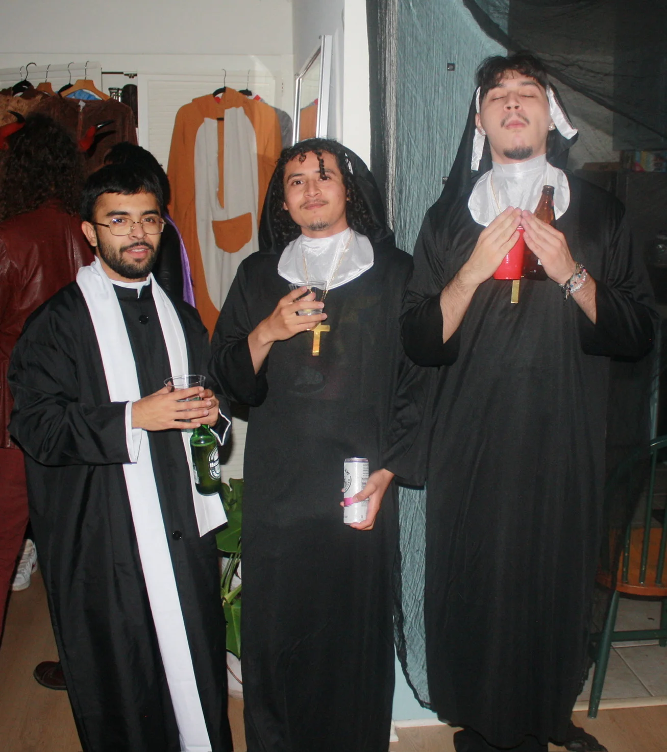 Three friends dressed in matching formal costumes